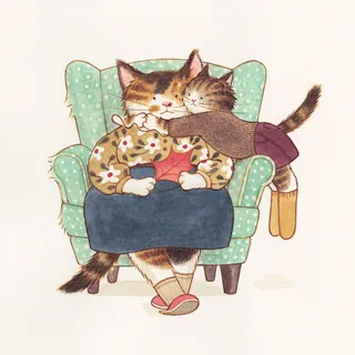 Two cats hugging on a green armchair wearing cozy clothes