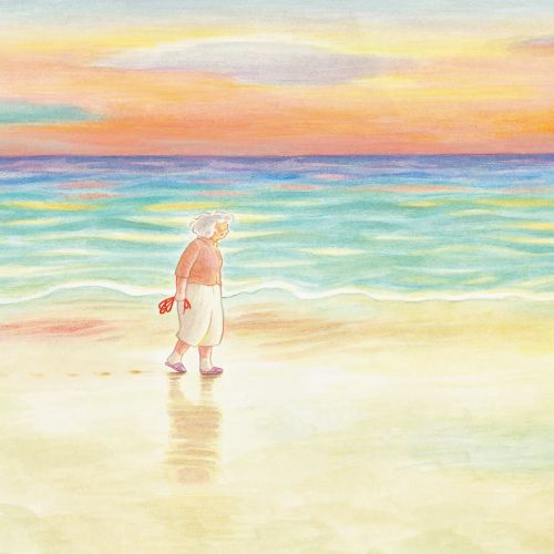 Child and small dog playing near water on a beach at sunset