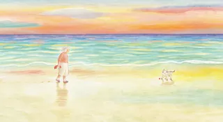 Child and small dog playing near water on a beach at sunset
