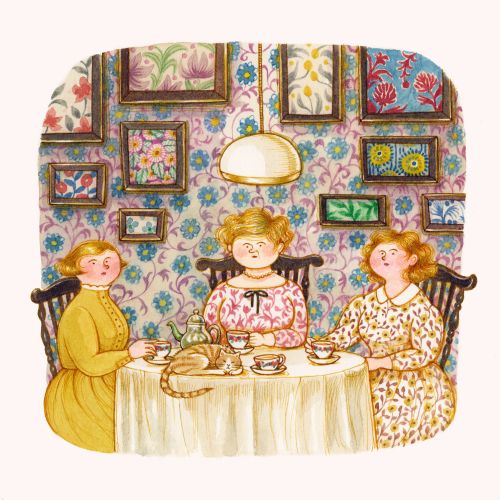 Three women sitting around a table drinking tea with a cat