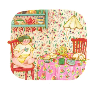 Person drinking tea in cozy kitchen with floral wallpaper and tablecloth