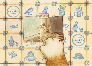 Cat paw holding photo of a cat looking out a window on tiled background