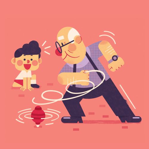 Grandfather spinning a top toy with grandson watching happily