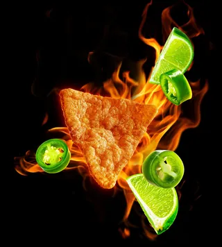 Fiery triangle protein crisp with lime wedges and jalapeno slices