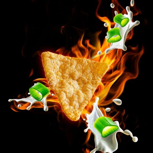 Triangular protein crisp with splashes of milk and green peas on fire