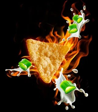 Triangular protein crisp with splashes of milk and green peas on fire