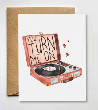 Vintage record player with 'You turn me on' text and small hearts