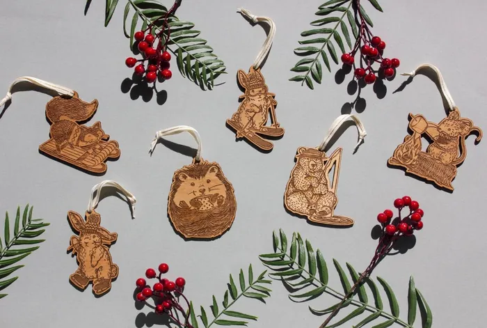 Woodland animal wooden ornaments with red berries and green leaves