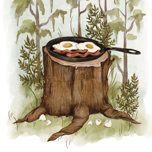 Fried eggs and bacon in skillet on tree stump, forest background by Fox and Fables