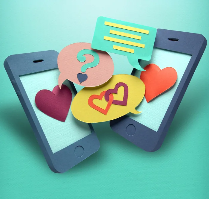 Paper smartphones with chat bubbles and hearts on teal background