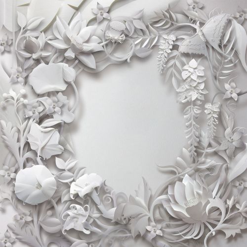 White floral paper cutout frame with leaves and flowers on white background