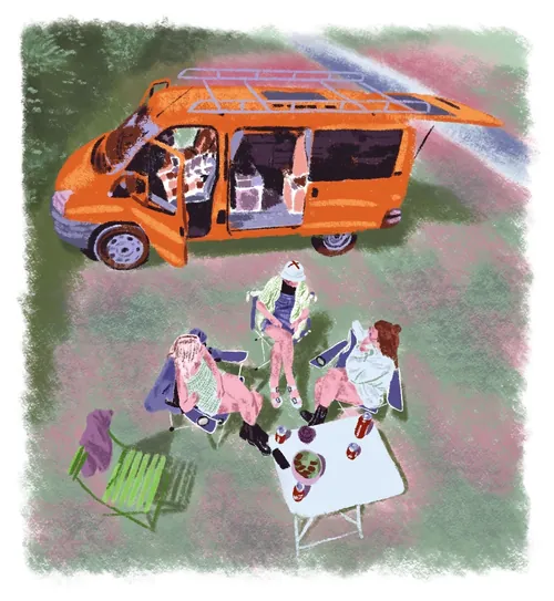 Three people sitting around table beside orange camper van by Georgie Stewart
