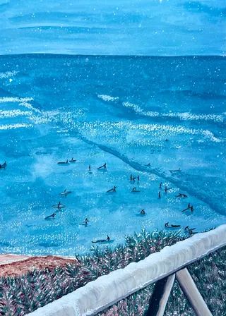 Ocean view with swimmers and surfers near the shoreline