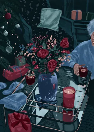 Christmas decorated living room with elderly person holding drink near lit candle