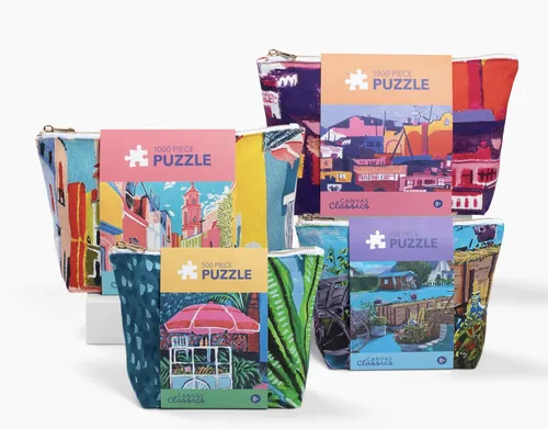 Georgie Stewart’s colorful illustrated jigsaw puzzle boxes arranged in a group