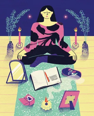 Woman meditating surrounded by candles, incense, open journal, and mirror.