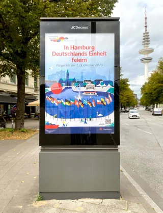 Poster celebrating German Unity Day in Hamburg with flags and skyline