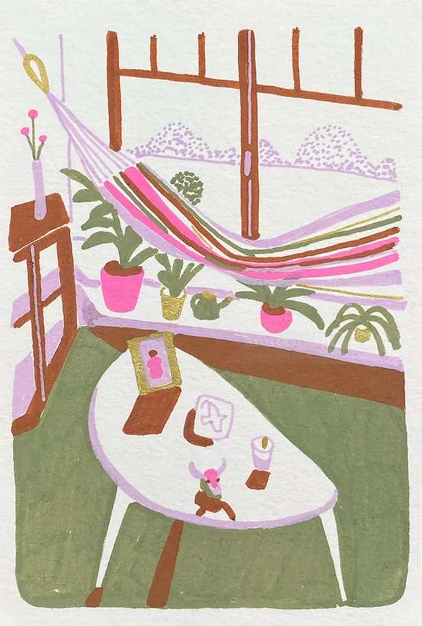 Indoor space with colorful hammock, plants, and a white table with items