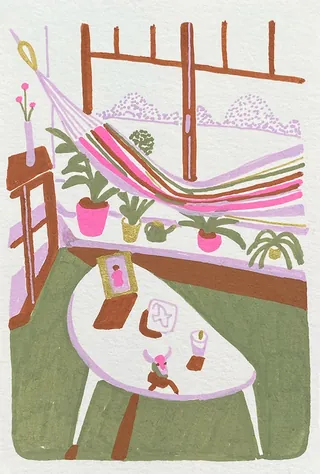 Indoor space with colorful hammock, plants, and a white table with items