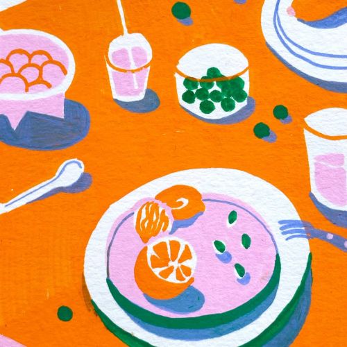 Bright table setting with plates of food, drinks, and utensils.