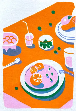 Bright table setting with plates of food, drinks, and utensils.