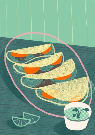 Four tacos with orange filling and a cup of sauce with lime wedges
