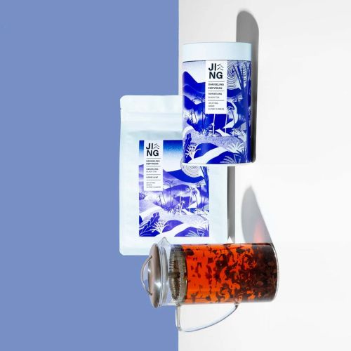 Tea packaging and glass cup with brewed tea by Gina Rosas Moncada