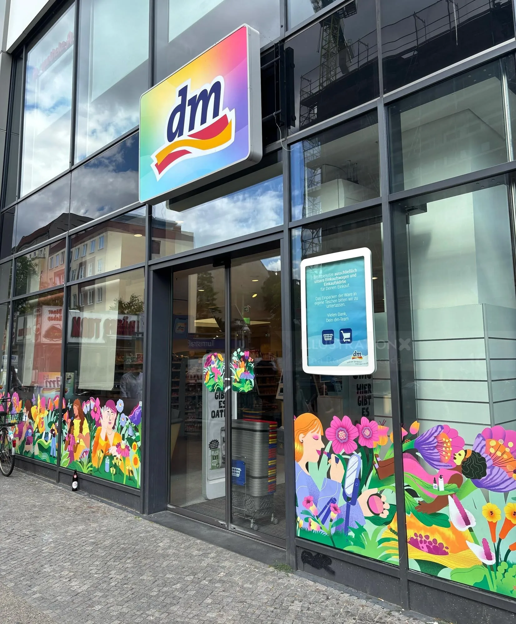 Gina Rosas Moncada’s colorful floral window art decorates a dm storefront.