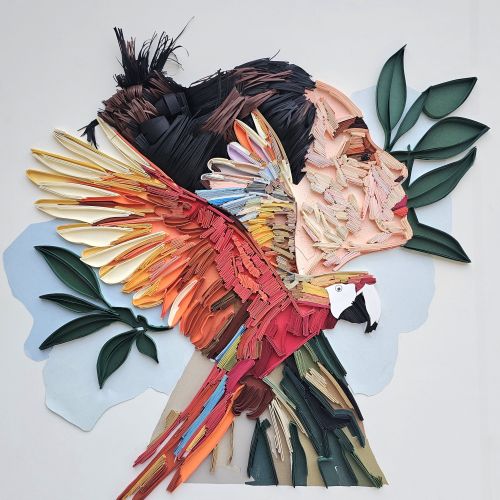 3D paper sculpture of woman’s profile with scarlet macaw by Glimpsecraft