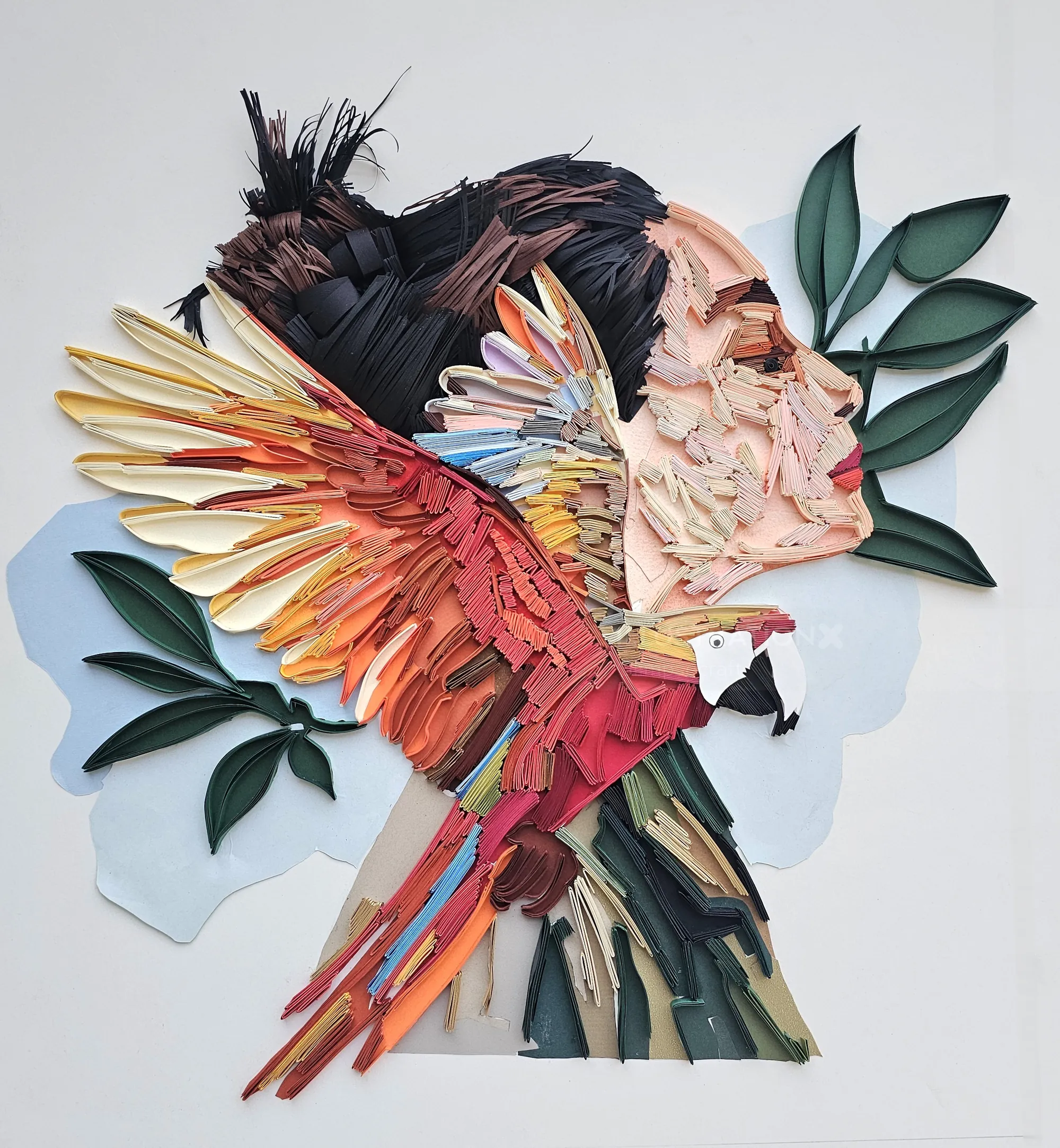 3D paper sculpture of woman’s profile with scarlet macaw by Glimpsecraft
