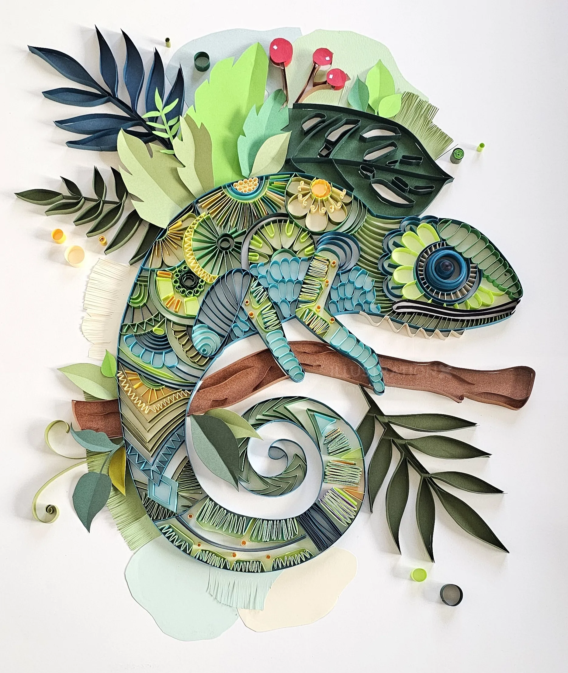 Colorful 3D paper quilling chameleon sculpture on a branch by Glimpsecraft