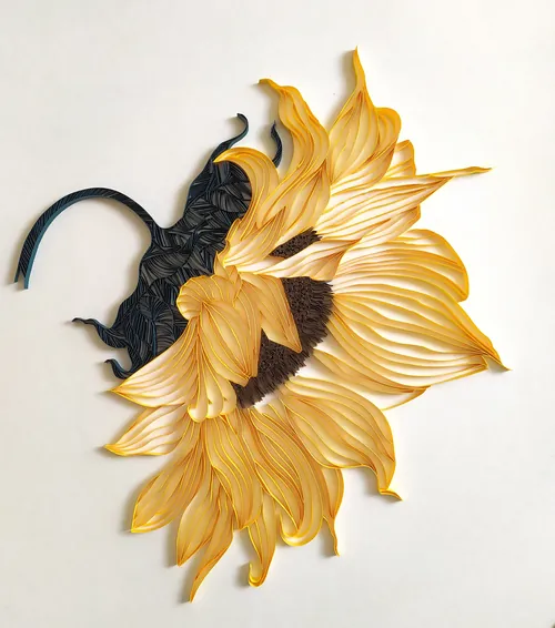 Paper quilling sunflower with yellow petals and dark brown center by Glimpsecraft