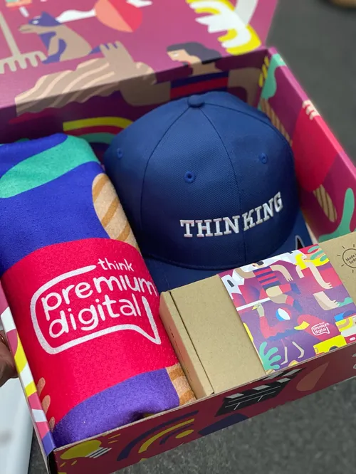 Box with THINKING cap, colorful towel, and patterned items by Go Suga