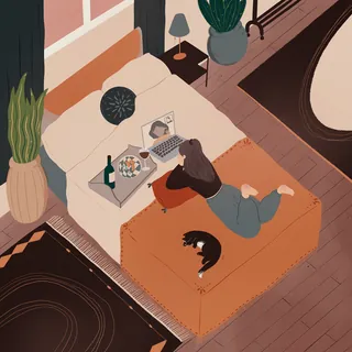 Woman lying on bed with laptop and cat beside her by Grace Lanksbury