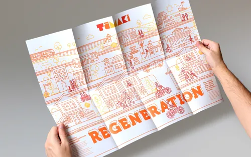 Hands holding a folded urban poster with the word REGENERATION by Greg Straight