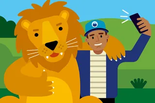 Person taking selfie with a friendly lion outdoors