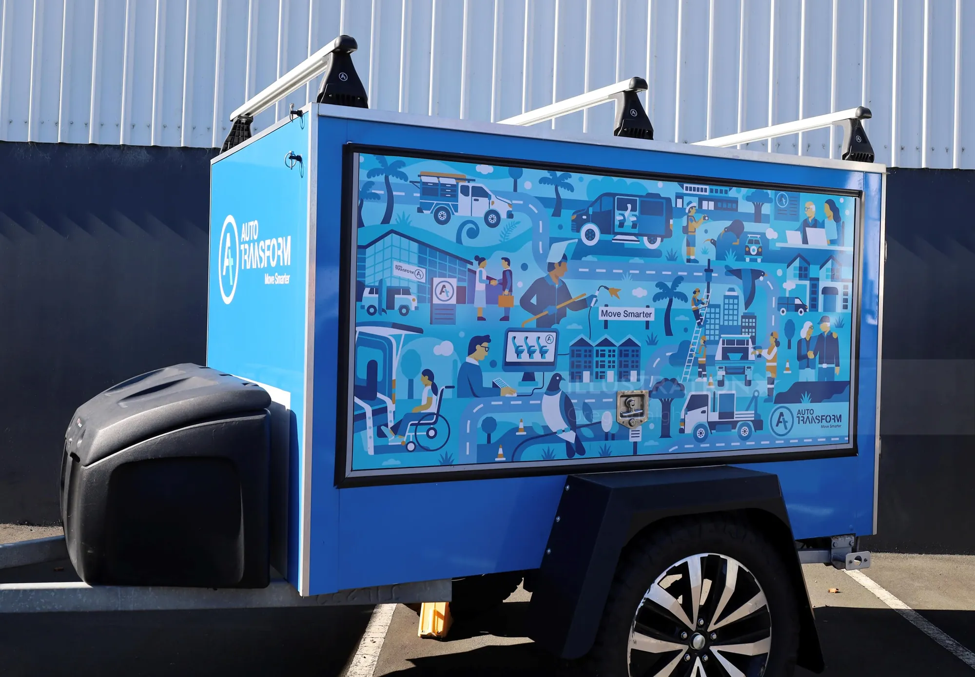Blue utility trailer featuring an illustrated infographic on the side panel.