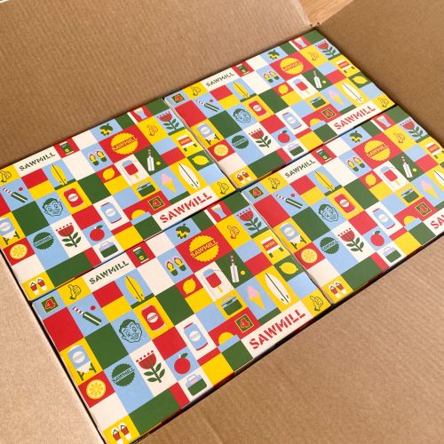 Colorful patterned cardboard boxes packed in a shipping box by Greg Straight