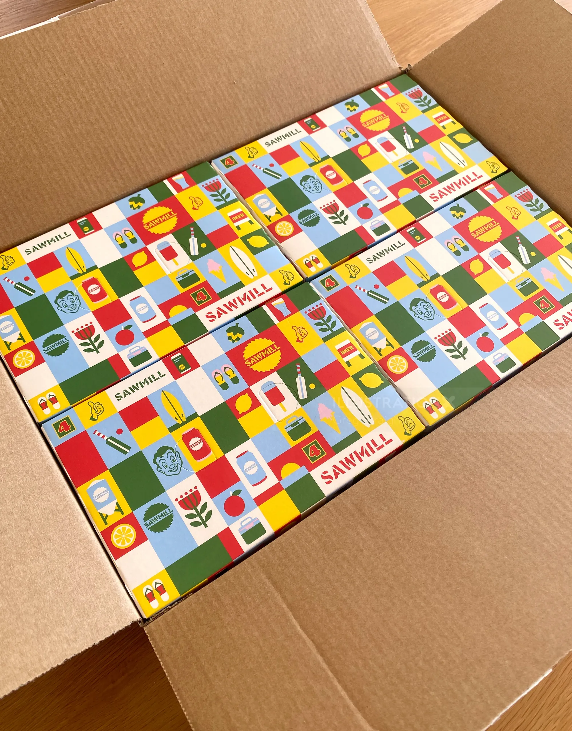 Colorful patterned cardboard boxes packed in a shipping box by Greg Straight