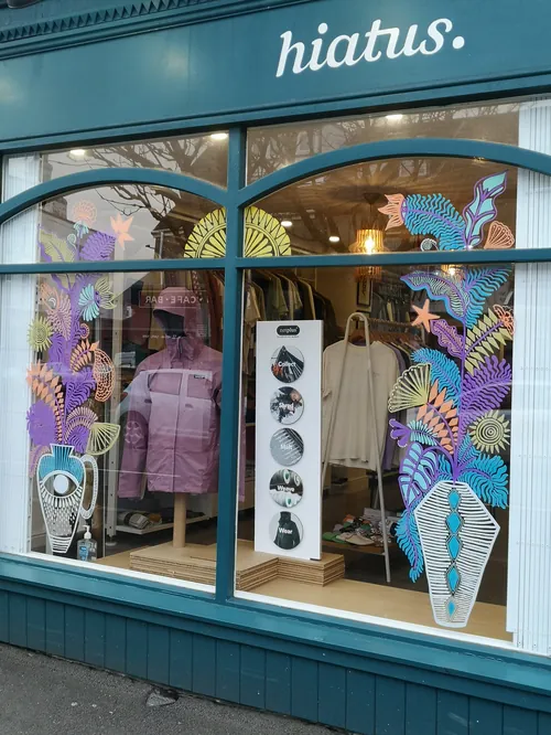 Window art painting by Hannah Davies with colorful sea-themed designs