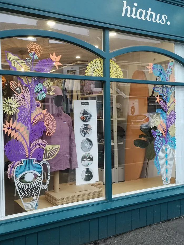 Window with colorful floral art by Hannah Davies at hiatus shop