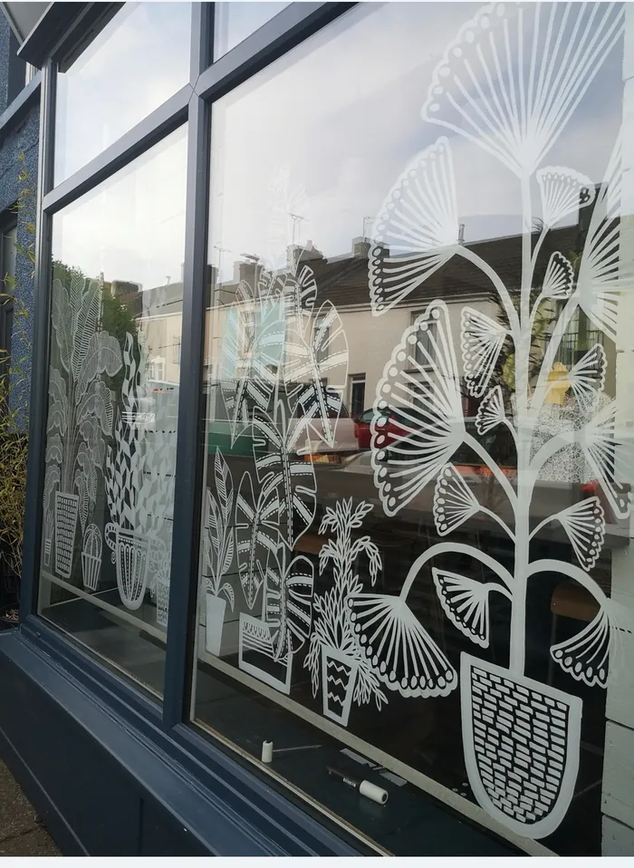 Window art of white botanical designs by Hannah Davies