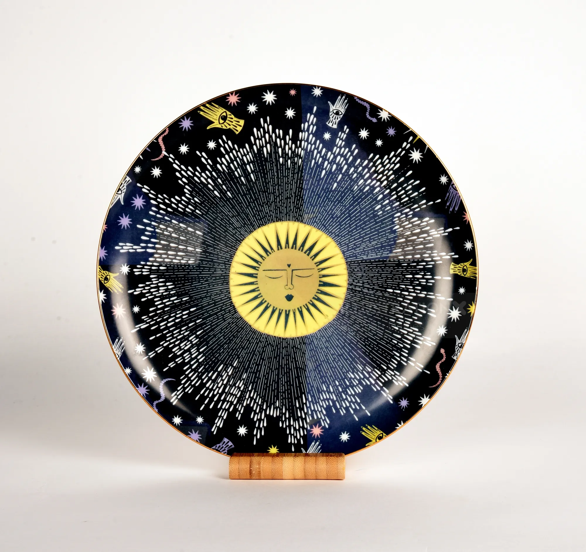 Ceramic plate with sun and star pattern by Hannah Davies