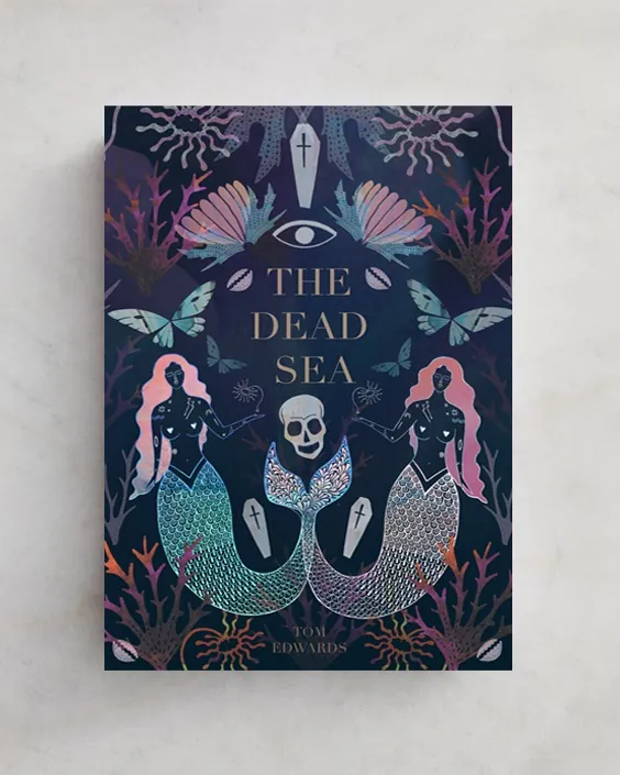 Book cover of The Dead Sea featuring mermaids and skull illustration by Hannah Davies