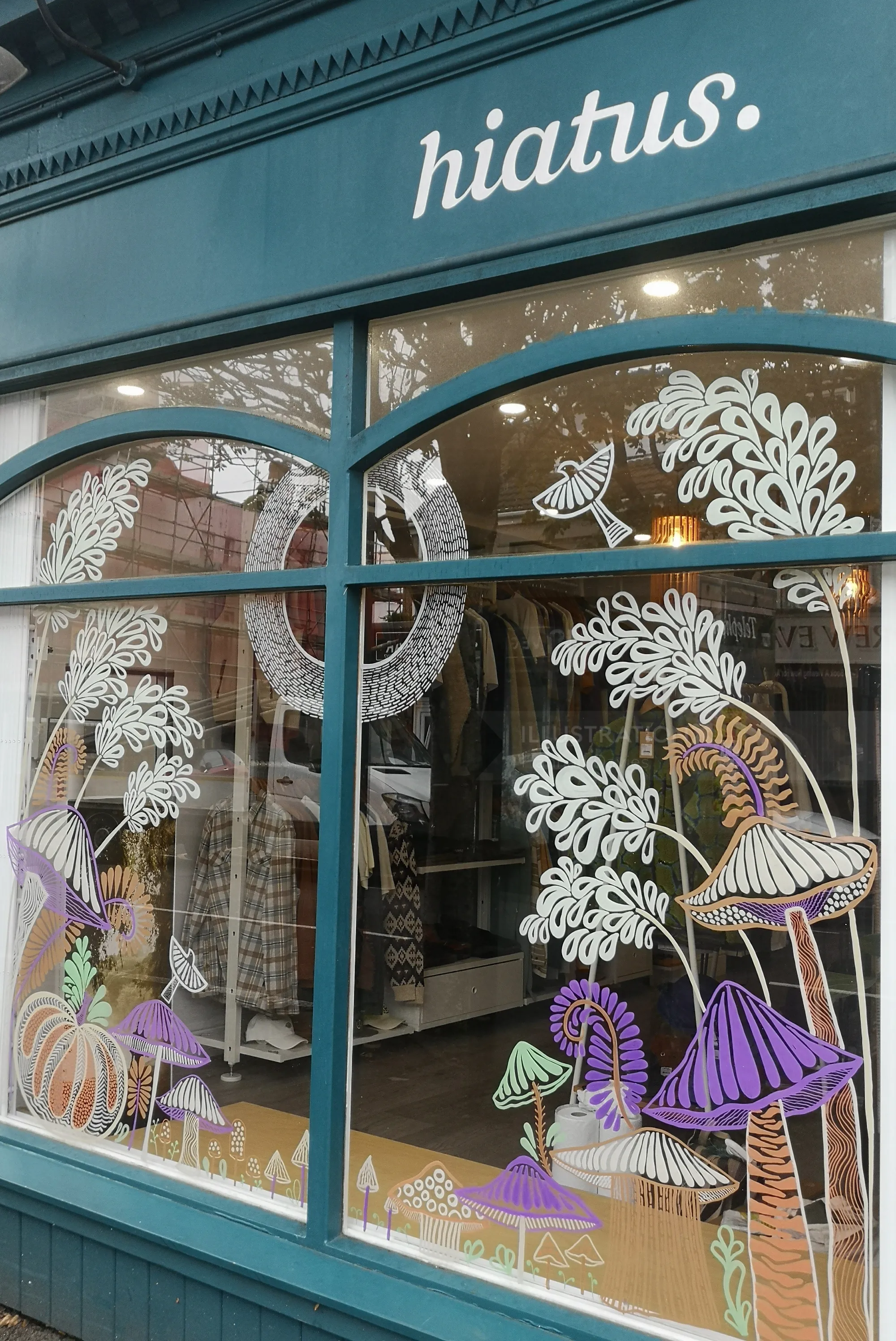 Window with whimsical mushroom and foliage art at Hiatus by Hannah Davies