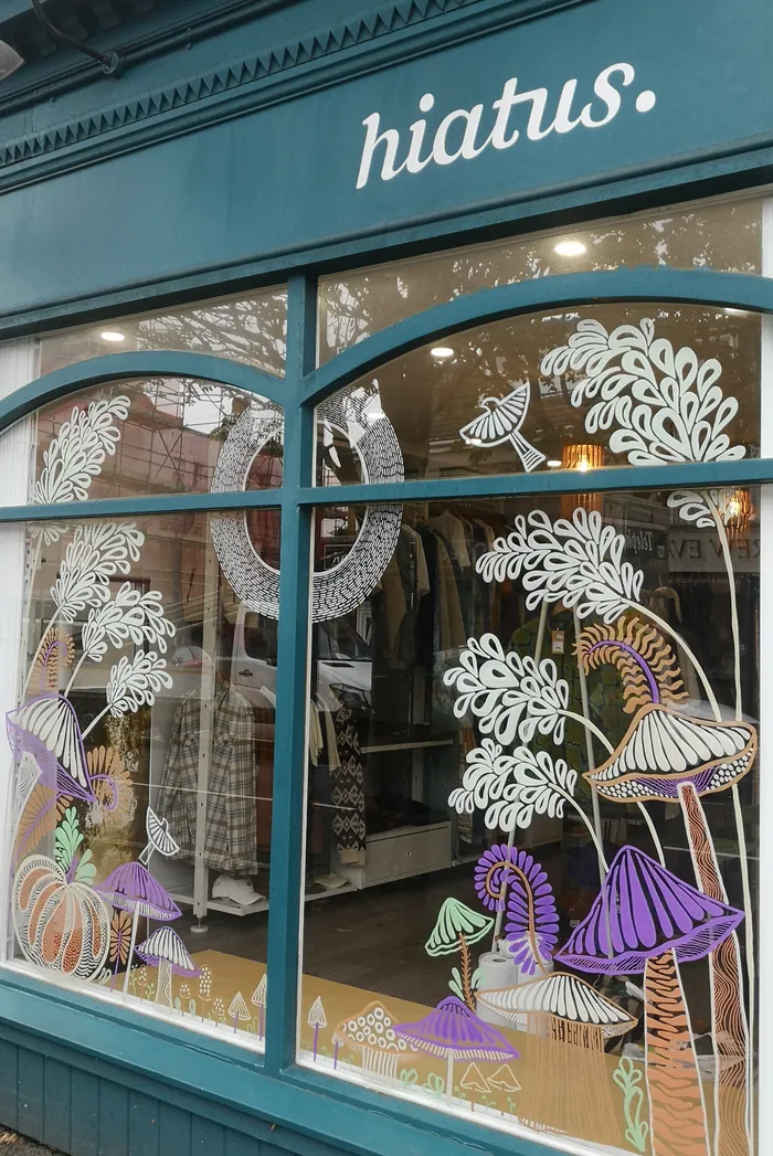 Window with whimsical mushroom and foliage art at Hiatus by Hannah Davies