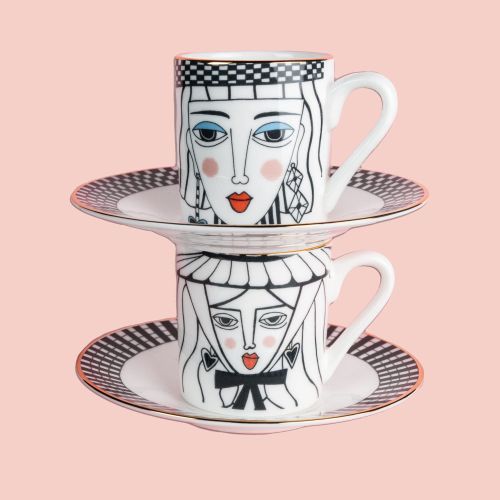 Two stacked illustrated teacups with faces on saucers by Hannah Davies