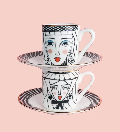 Two stacked illustrated teacups with faces on saucers by Hannah Davies