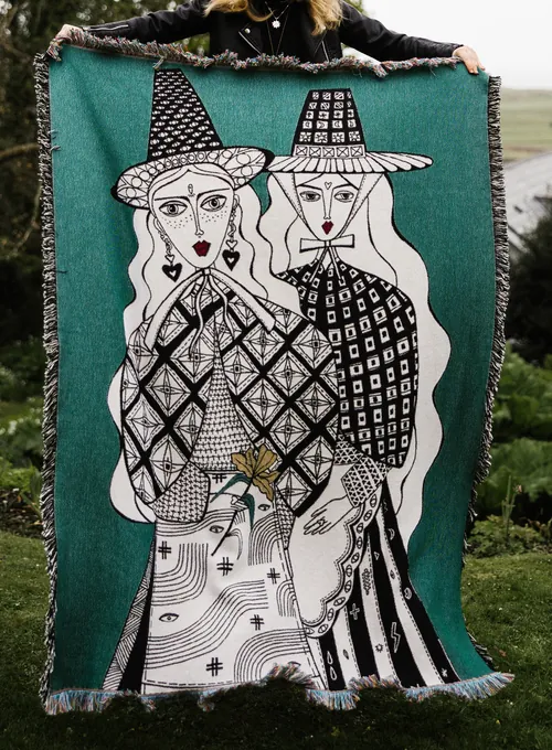 Woven textile artwork showing two stylized figures wearing hats by Hannah Davies