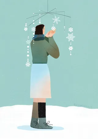 Person holding snowflake mobile with winter outfit by Hao Hao